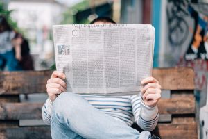 Person reading a newspaper (Unsplash).jpg